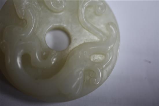 A Chinese white jade bi disc, diameter 4.6cm, wood stand